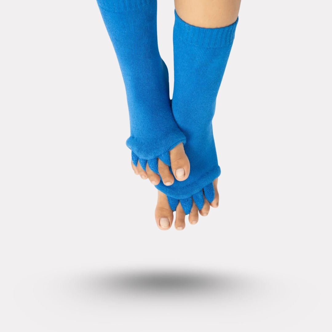 Bunion correction socks in black, gray, green and blue, worn over the forefoot and big toe