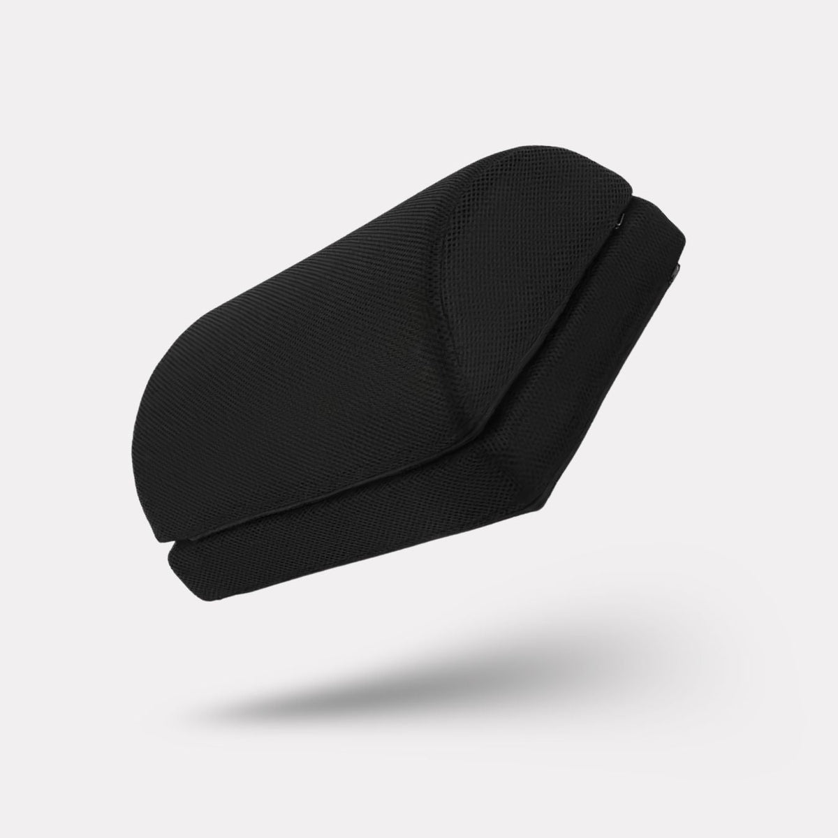 Angled ergonomic footrest placed under a desk to support both feet while seated