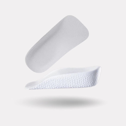 Pair of invisible height increase heel lifts placed under the heel inside the shoe