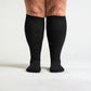 Black compression socks cut for wide calves with a graduated knit