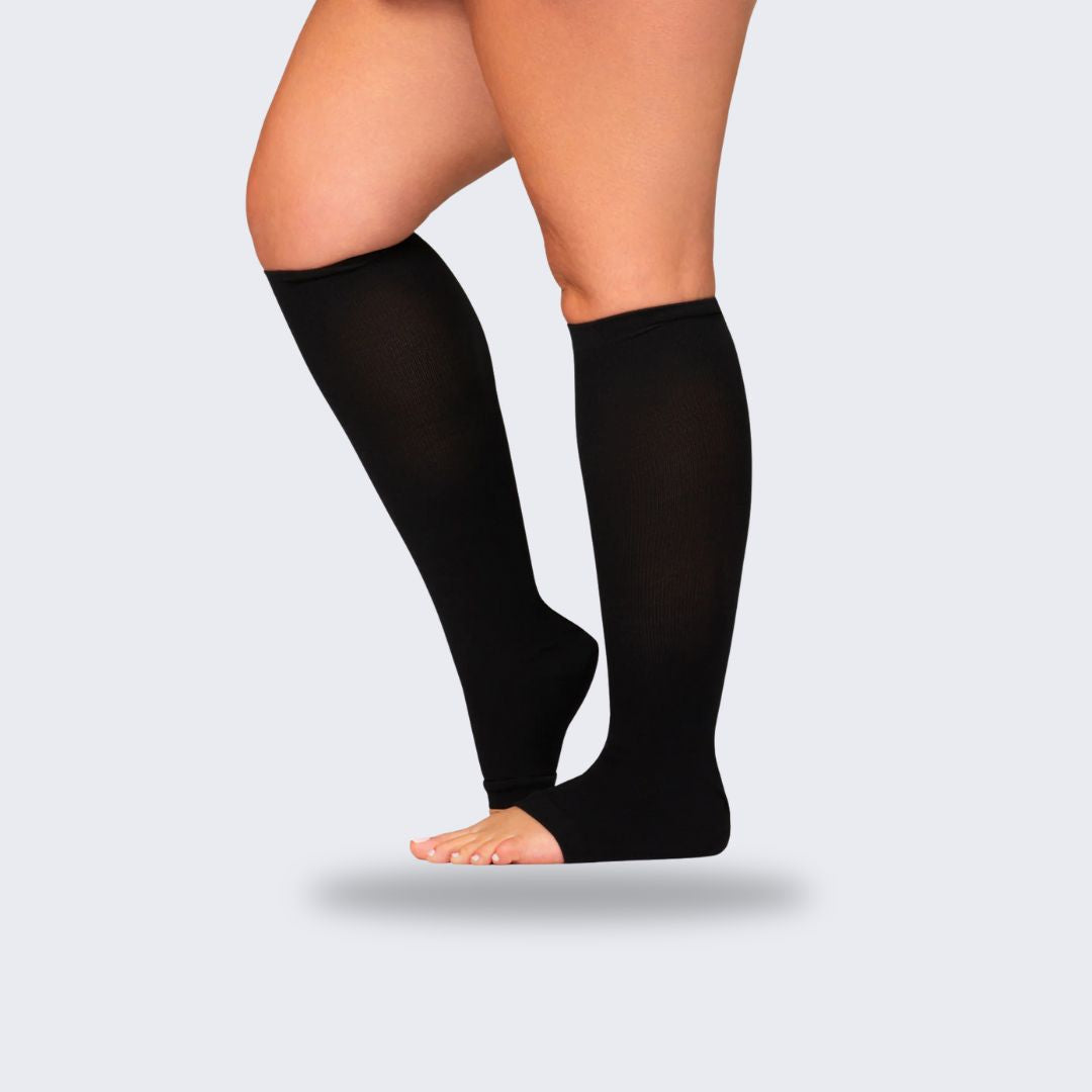 Breathable open-toe compression socks in black and beige, worn up the calf