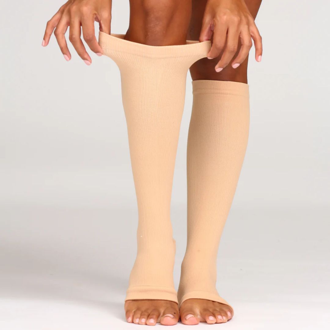 Breathable open-toe compression socks in black and beige, worn up the calf