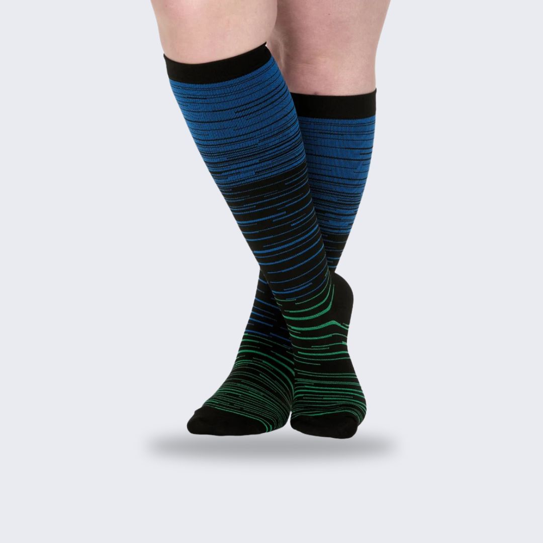 Two-tone 20-30 mmHg compression socks worn up the calf, in black, pink, blue and light blue