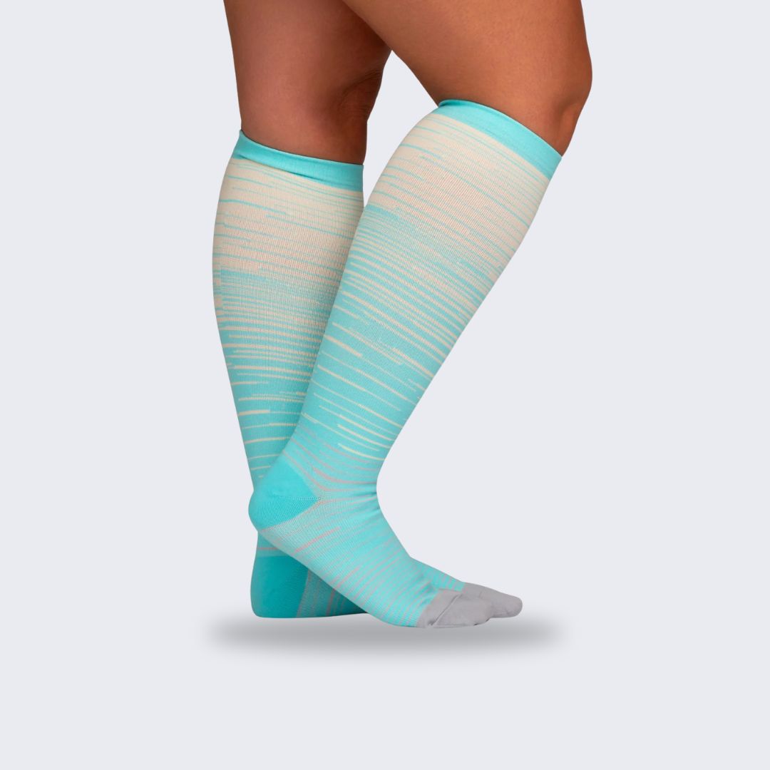 Two-tone 20-30 mmHg compression socks worn up the calf, in black, pink, blue and light blue