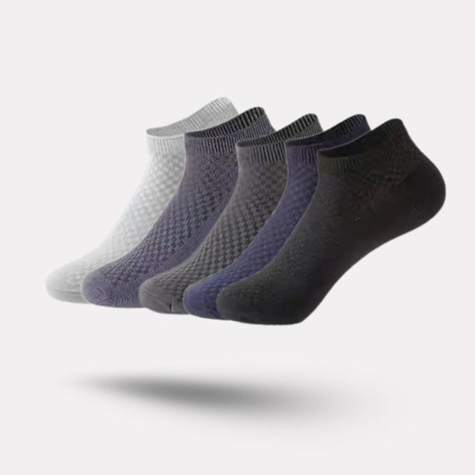 Five pairs of soft bamboo fiber socks in black and gray, worn up to mid-calf