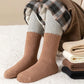 Five pairs of thick knit winter socks for kids, worn up to mid-calf