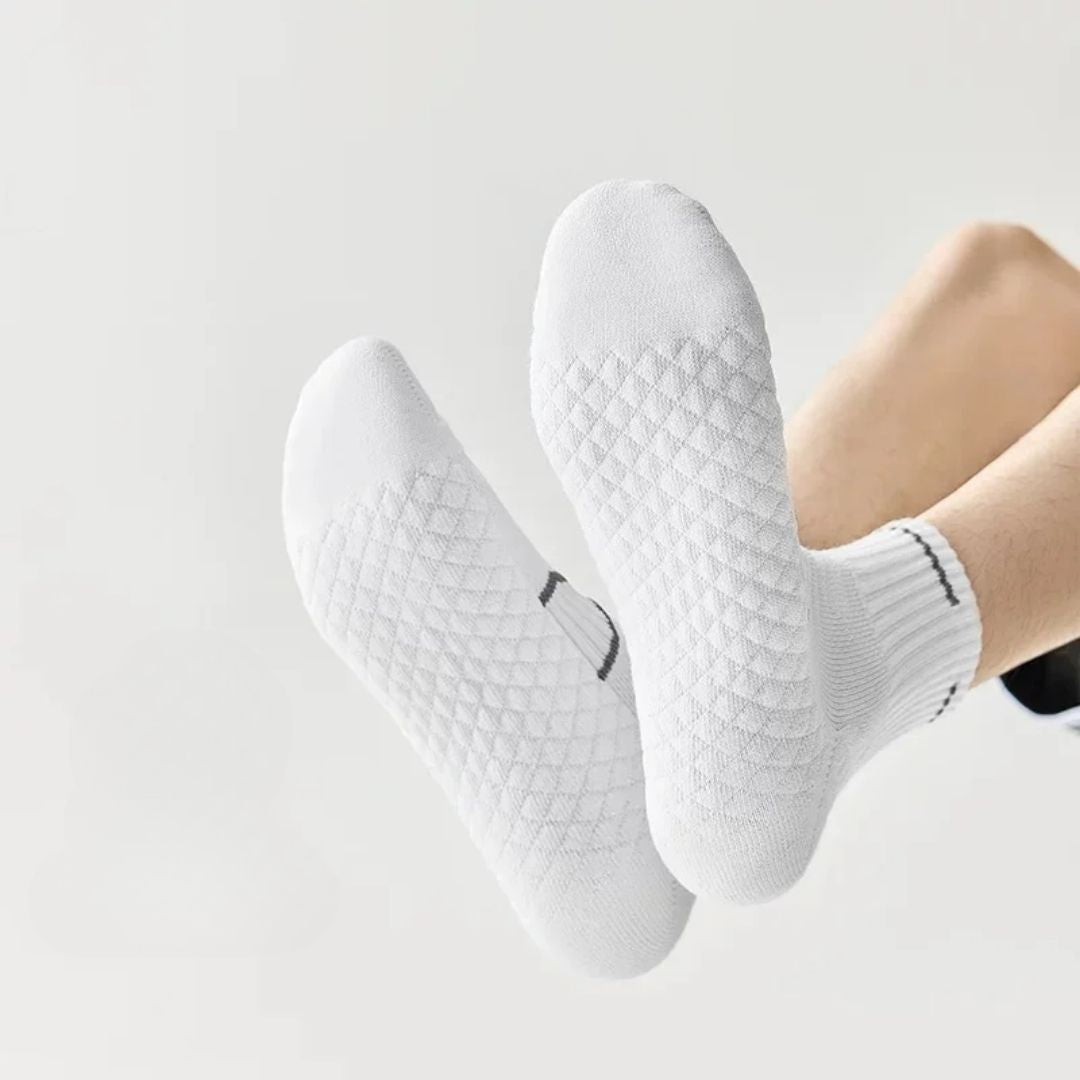Black and white running socks in ankle and crew heights with a reinforced arch band
