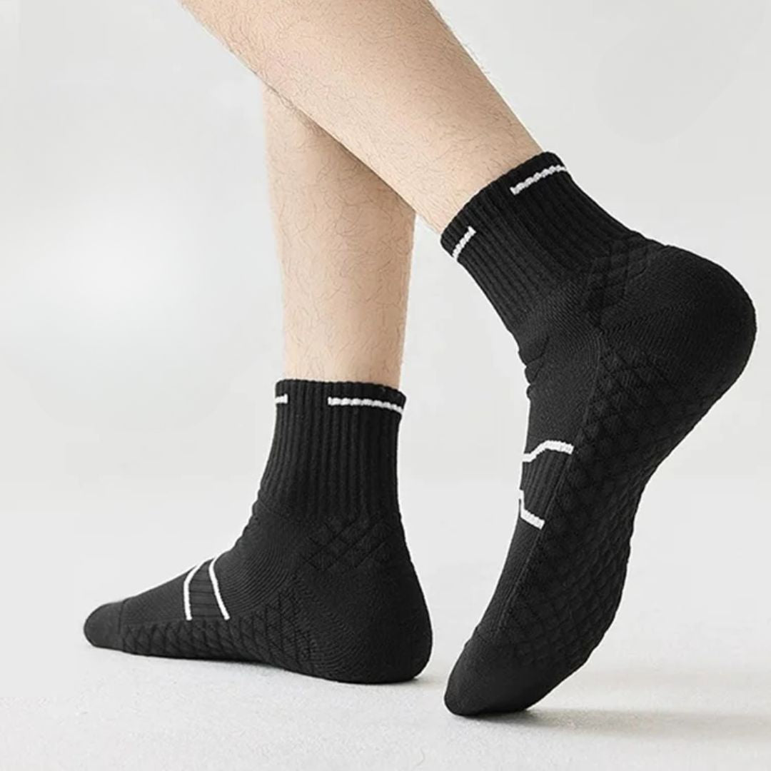 Black and white running socks in ankle and crew heights with a reinforced arch band