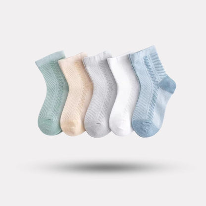 Four pairs of soft breathable cotton socks for children, worn on the foot and ankle