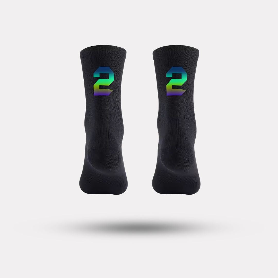 Black cycling socks with reflective stripes, worn high on the calf