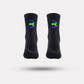 Black cycling socks with reflective stripes, worn high on the calf