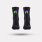 Black cycling socks with reflective stripes, worn high on the calf