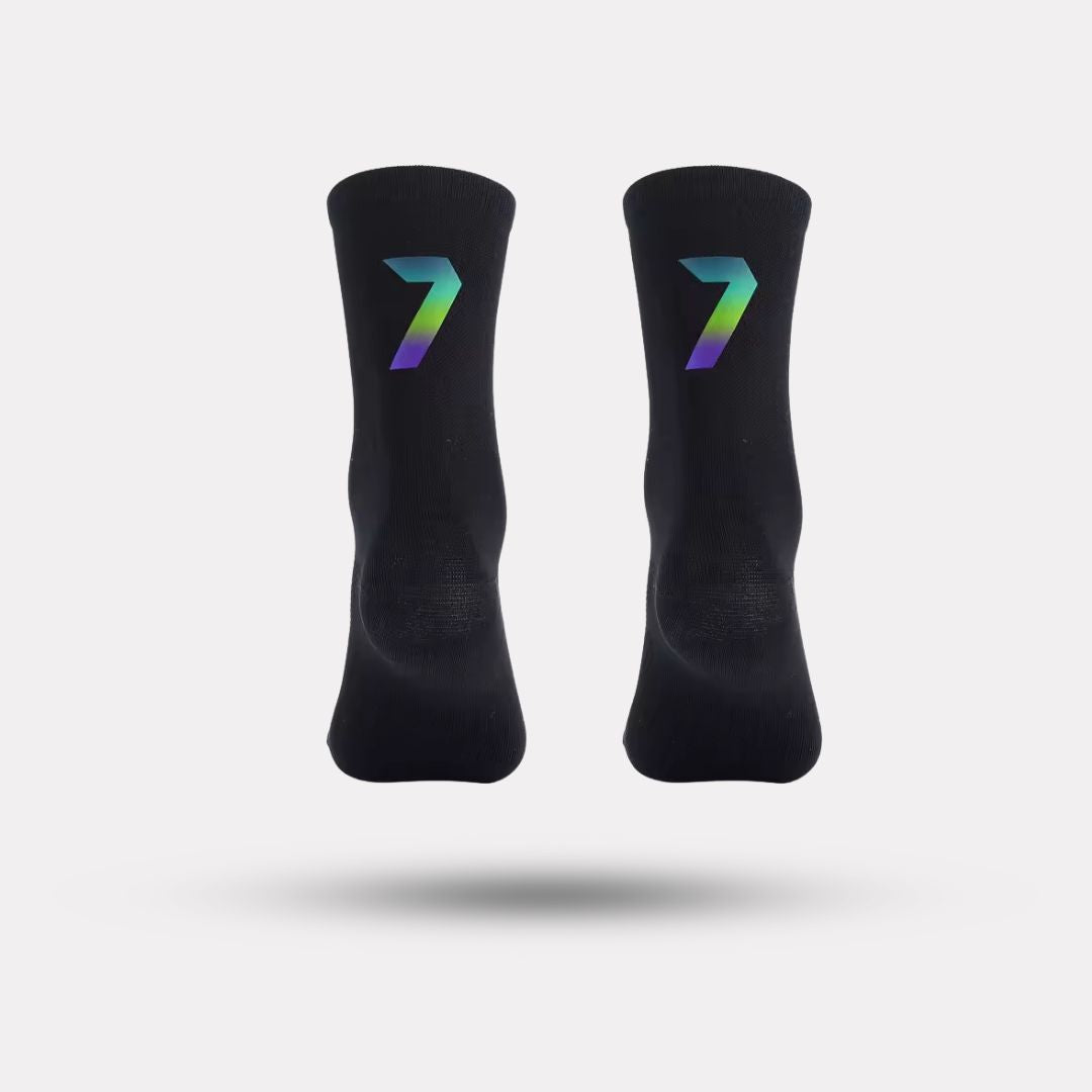 Black cycling socks with reflective stripes, worn high on the calf