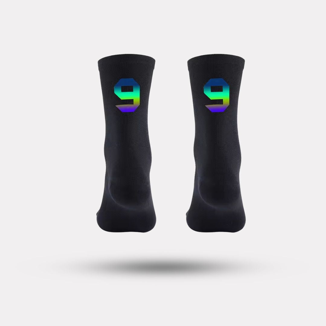Black cycling socks with reflective stripes, worn high on the calf