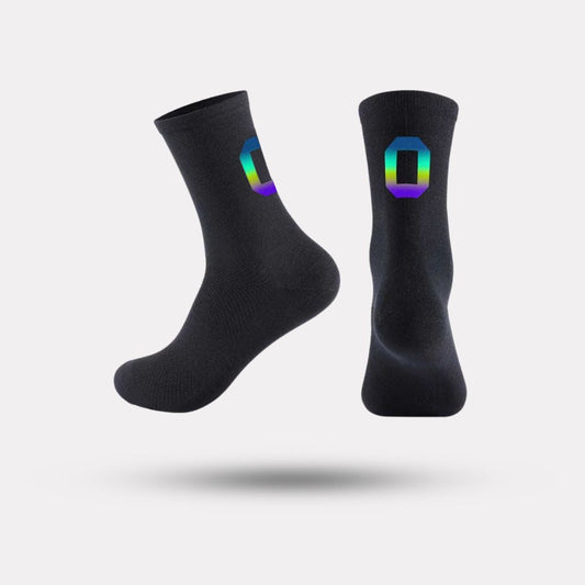 Black cycling socks with reflective stripes, worn high on the calf