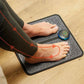 Flat EMS foot massager mat with electrode pads that the soles of the feet rest on