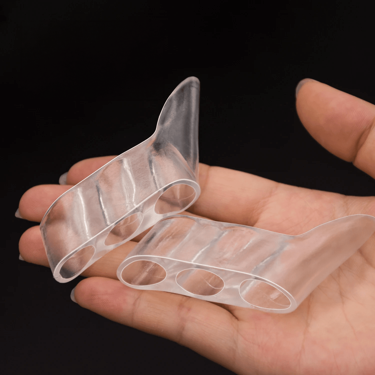 Soft silicone splint worn over the little toe to cushion and straighten it