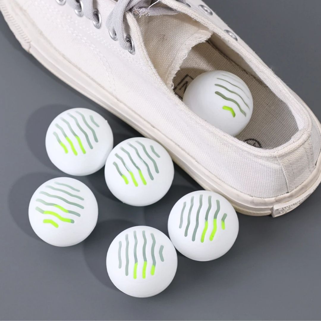 Pair of shoe deodorizer balls dropped inside shoes to absorb odor between wears