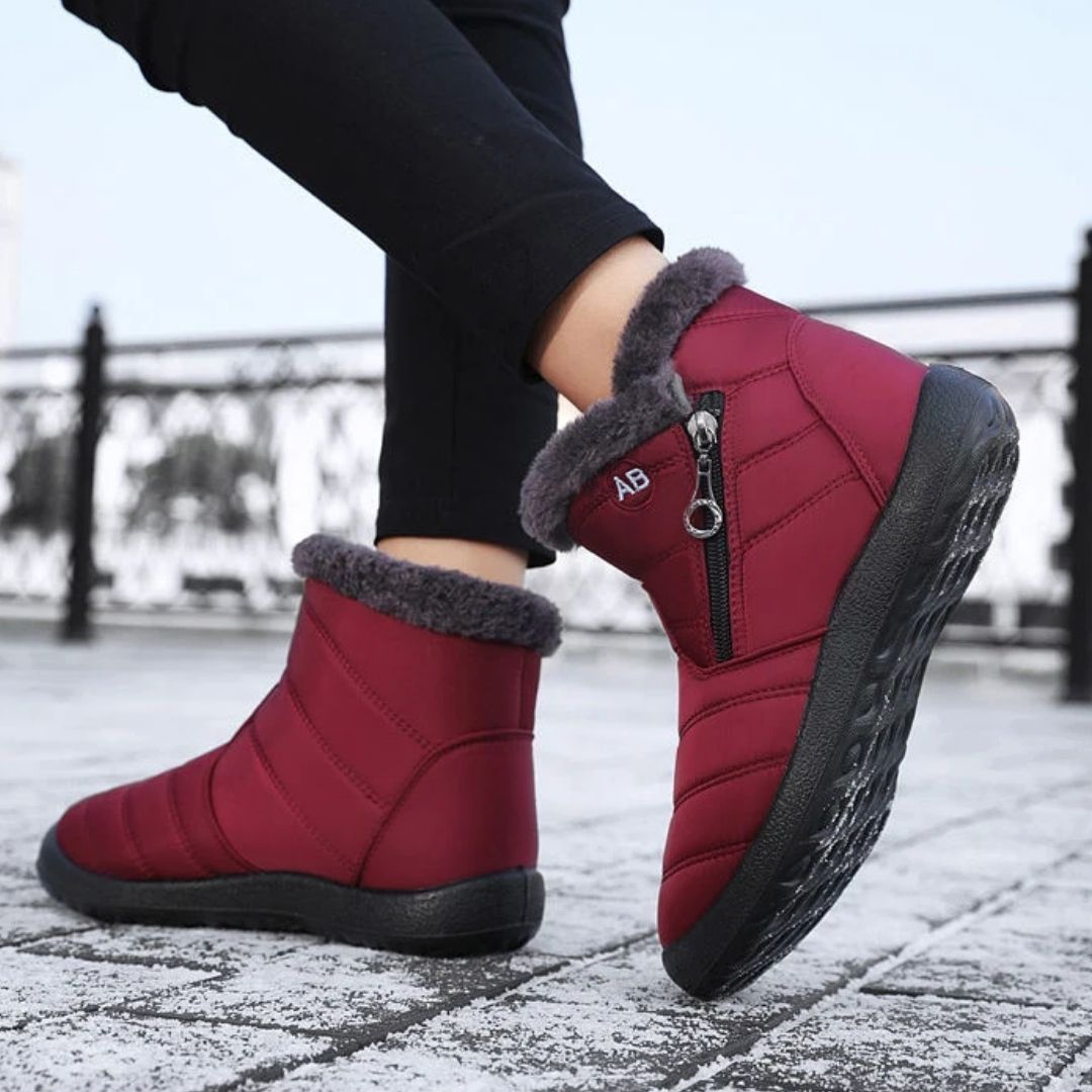 Navy waterproof snow boots for women, lined and reaching mid calf