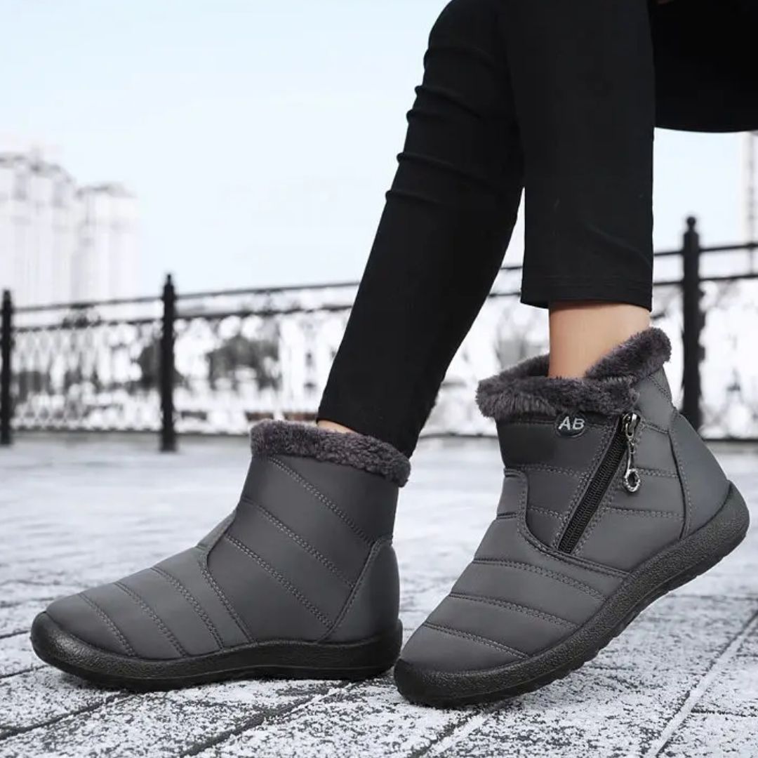 Navy waterproof snow boots for women, lined and reaching mid calf