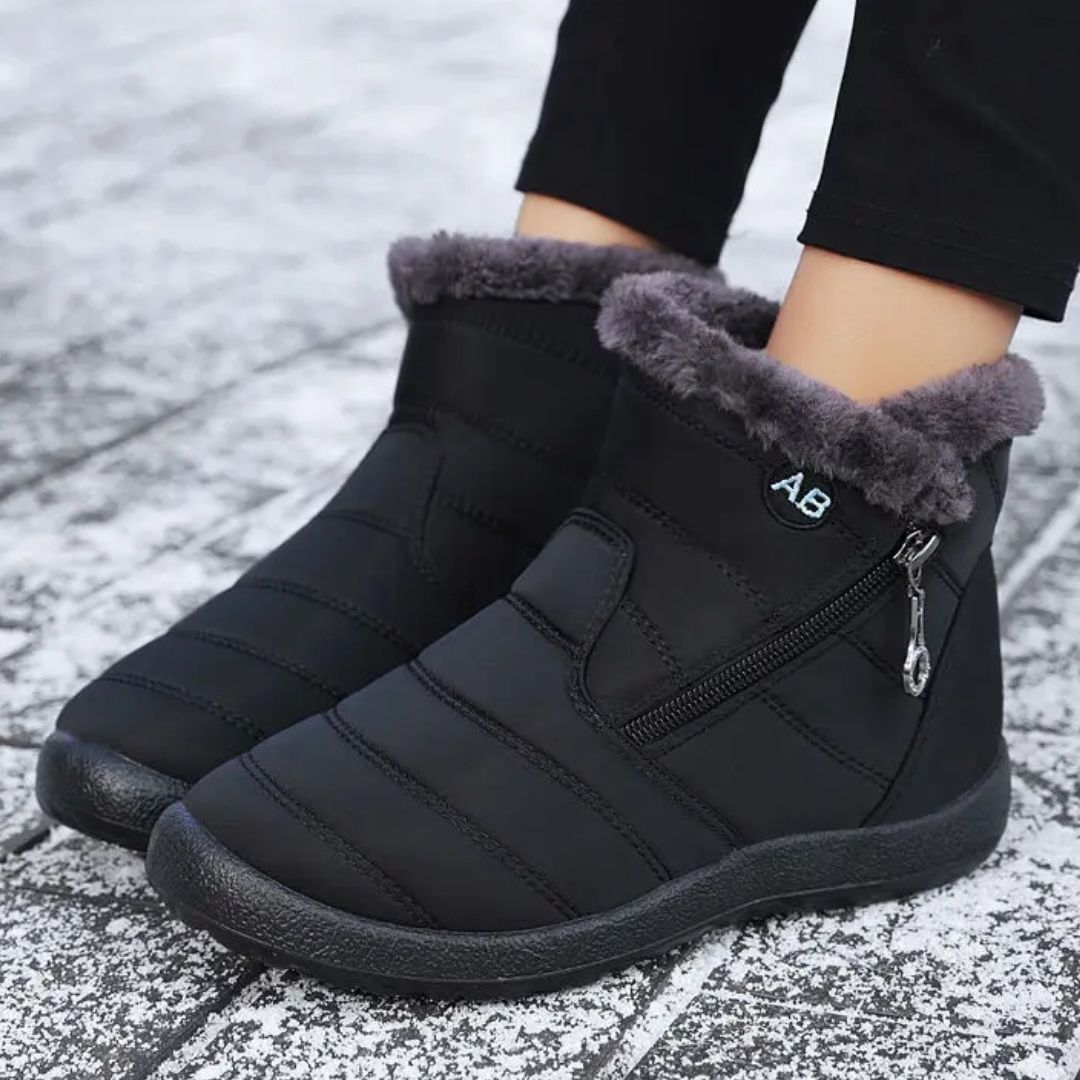 Navy waterproof snow boots for women, lined and reaching mid calf