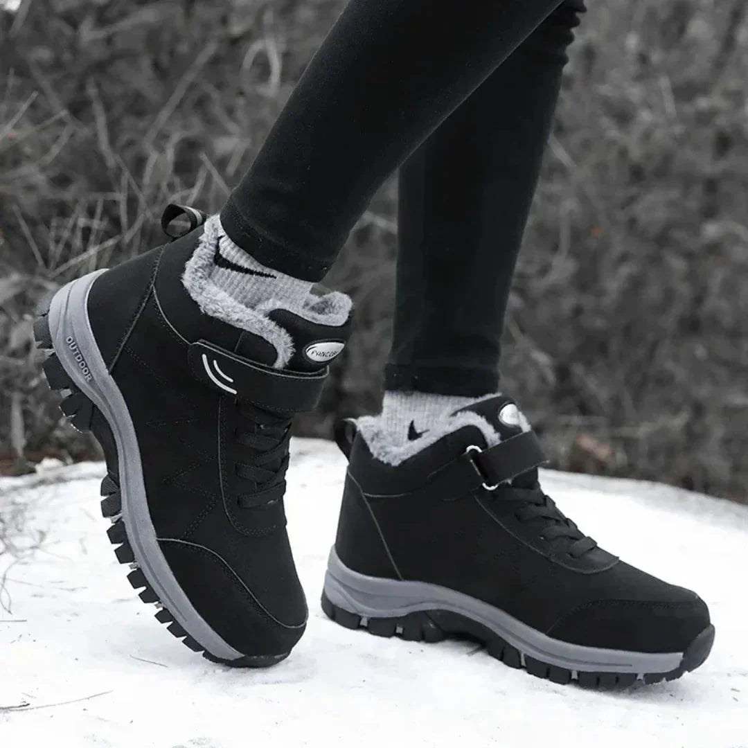 Black fleece lined orthopedic boots reaching just above the ankle