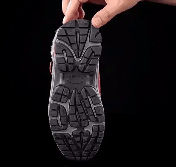 Black fleece lined orthopedic boots reaching just above the ankle