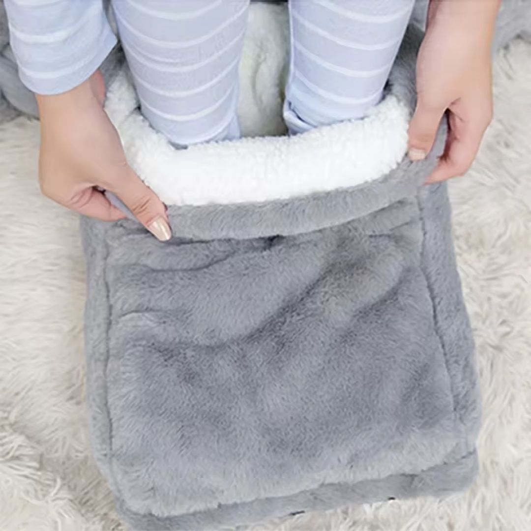 Gray plush heated foot warmer that both feet slide into for gentle warmth