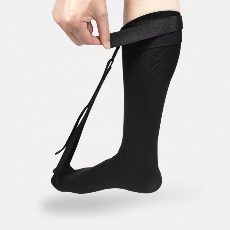 Black night socks worn over the foot and ankle to stretch the plantar arch