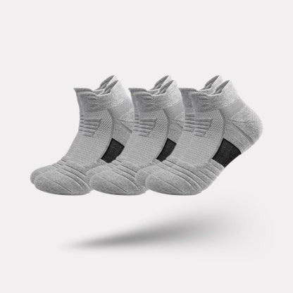 Three pairs of non-slip grip socks with rubber dots on the sole, in gray, black or white