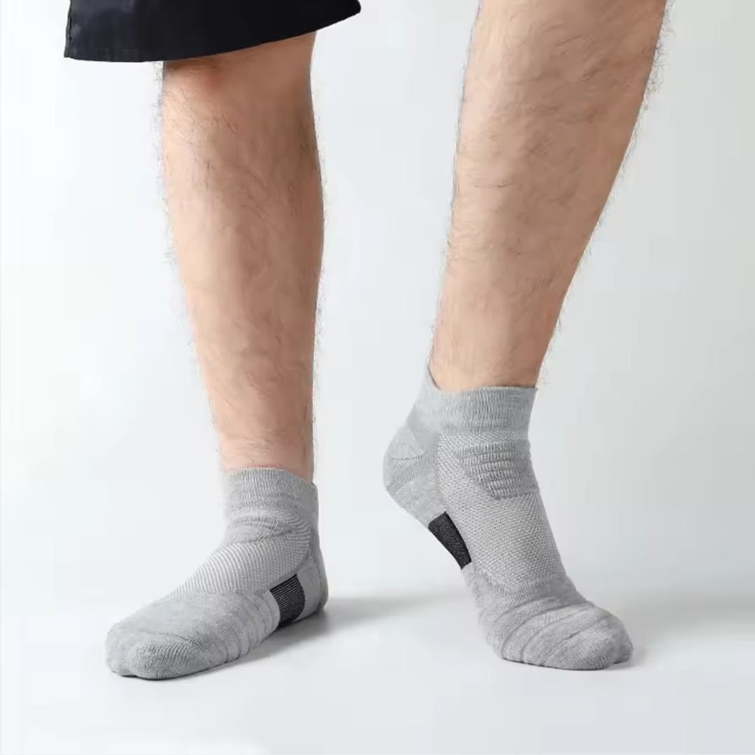 Three pairs of non-slip grip socks with rubber dots on the sole, in gray, black or white