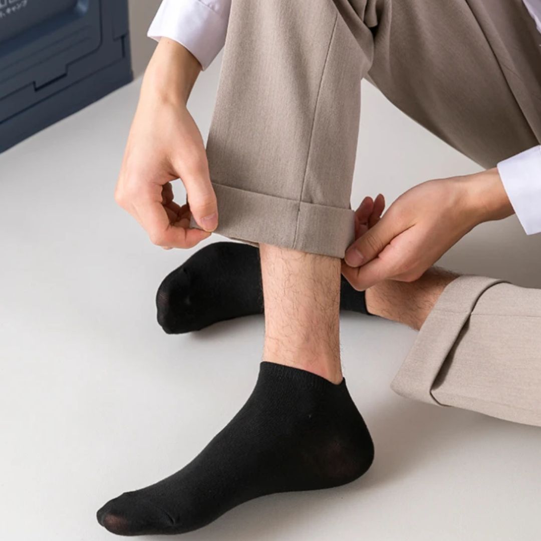 Low-cut odor-control socks in black and white, cut to sit just below the ankle bone