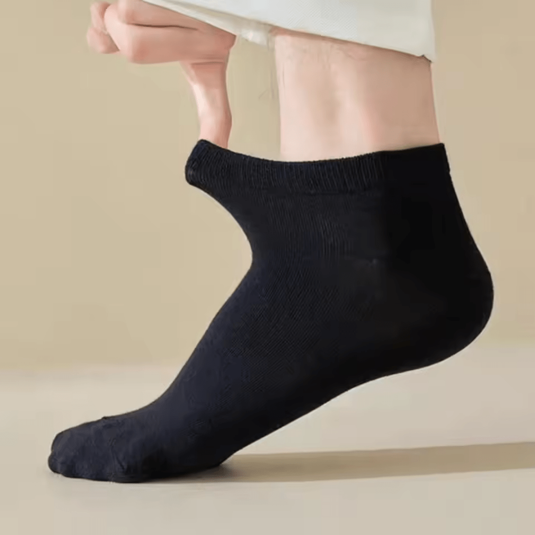 Low-cut odor-control socks in black and white, cut to sit just below the ankle bone