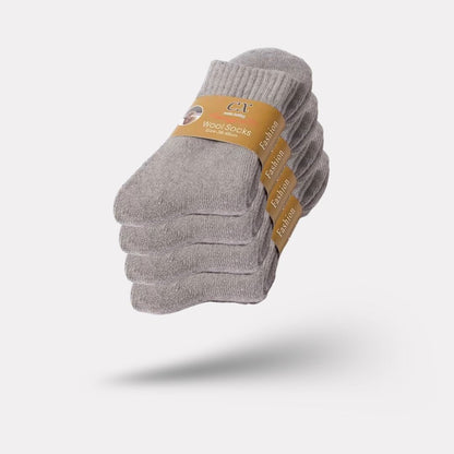 Thick merino wool winter socks in gray, black, khaki and brown, pulled up over the calf