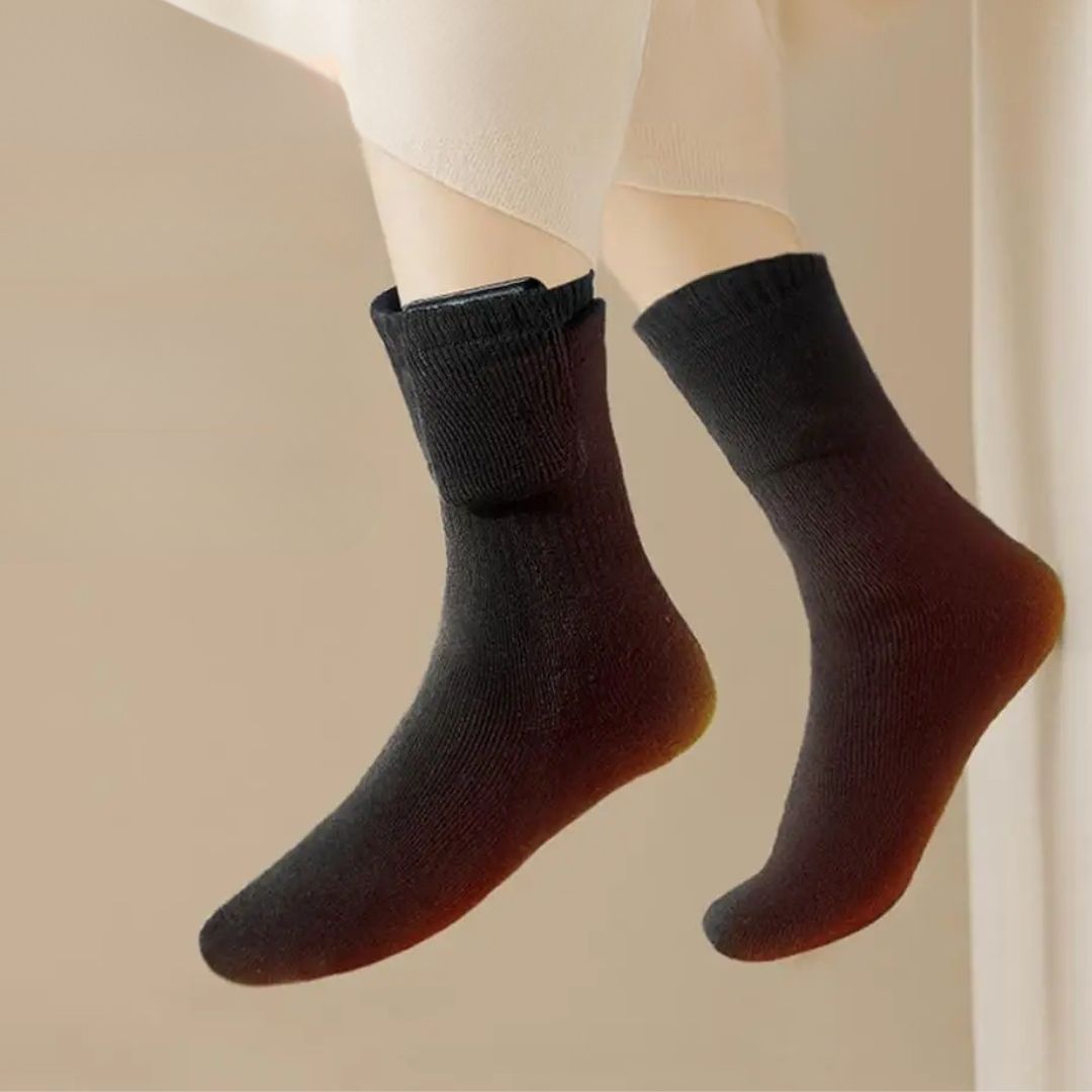 Rechargeable heated socks with a battery pack sitting at the top of the calf