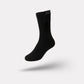 Rechargeable heated socks with a battery pack sitting at the top of the calf