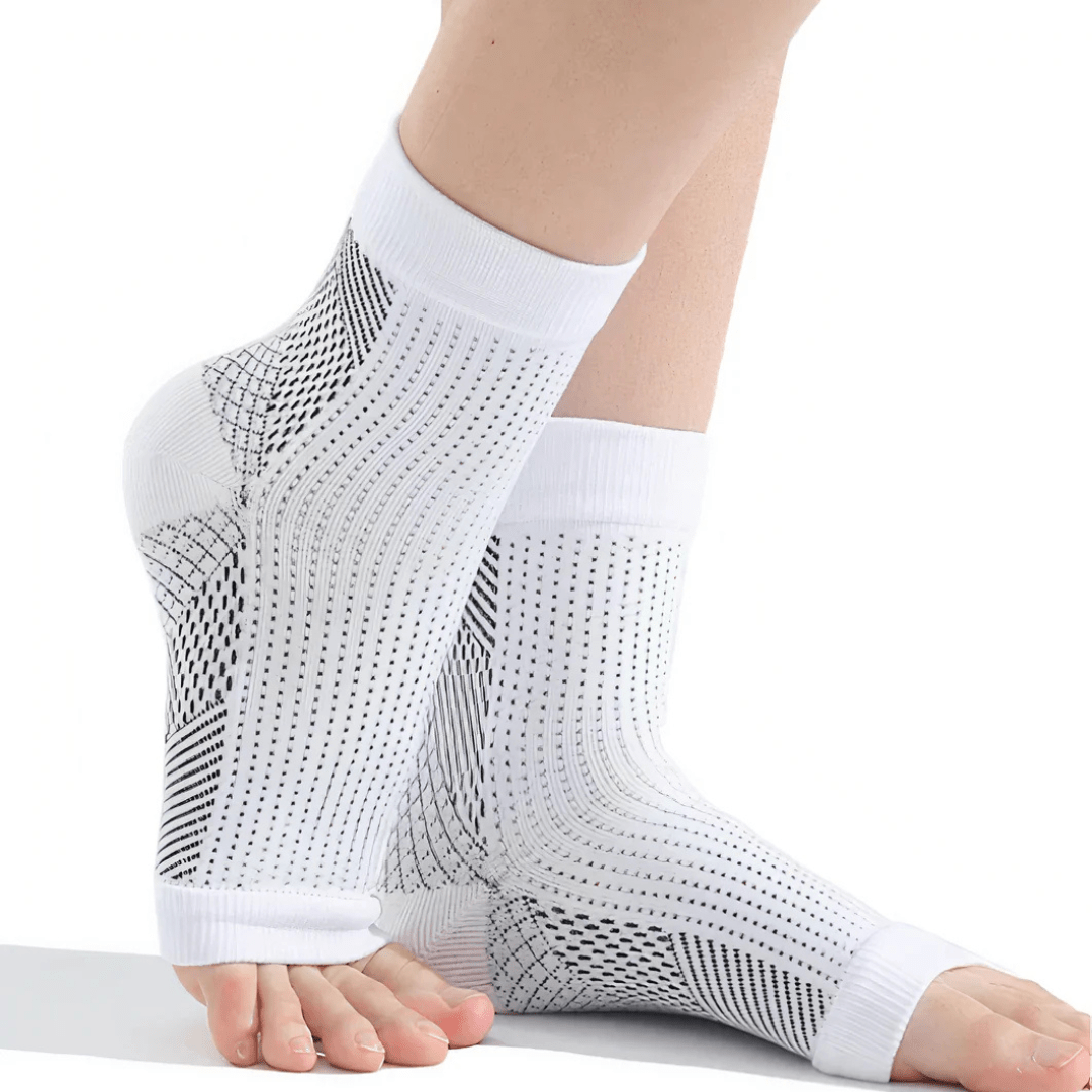 White and black anti-fatigue compression socks with flat seams, worn up the calf