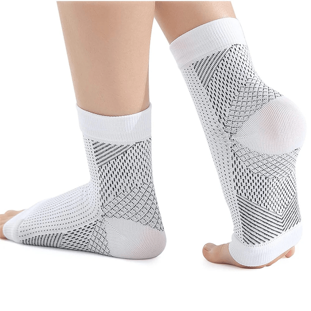 White and black anti-fatigue compression socks with flat seams, worn up the calf