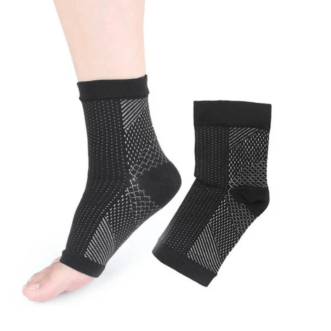 White and black anti-fatigue compression socks with flat seams, worn up the calf