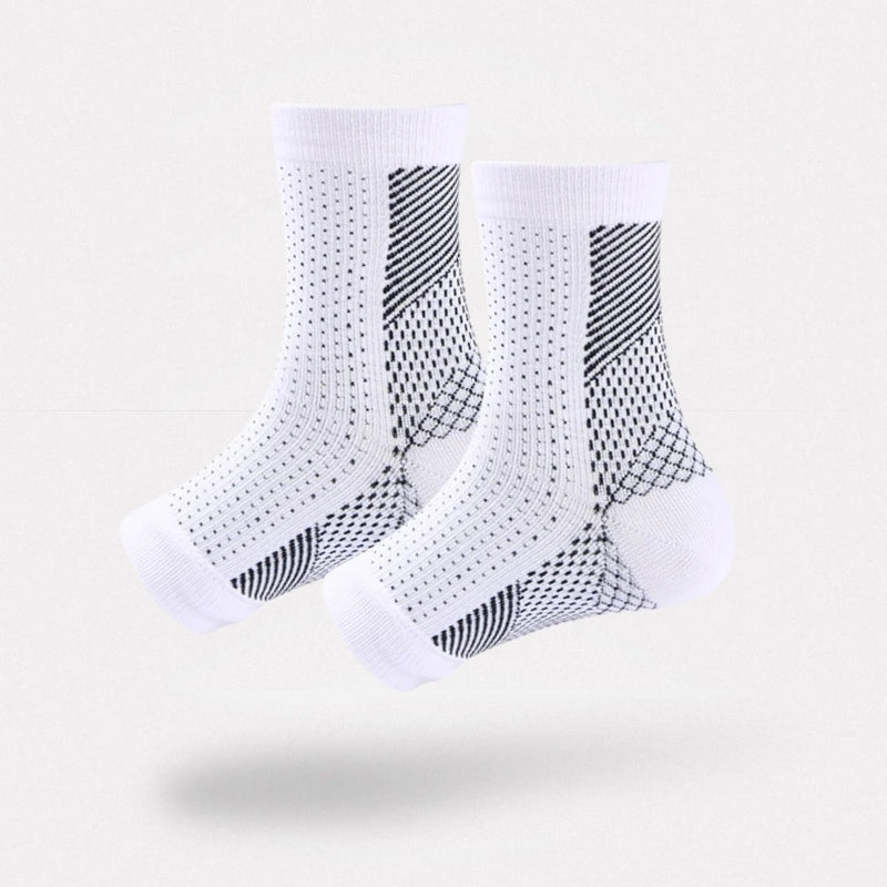 White and black anti-fatigue compression socks with flat seams, worn up the calf