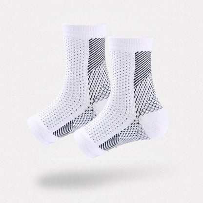 White and black anti-fatigue compression socks with flat seams, worn up the calf