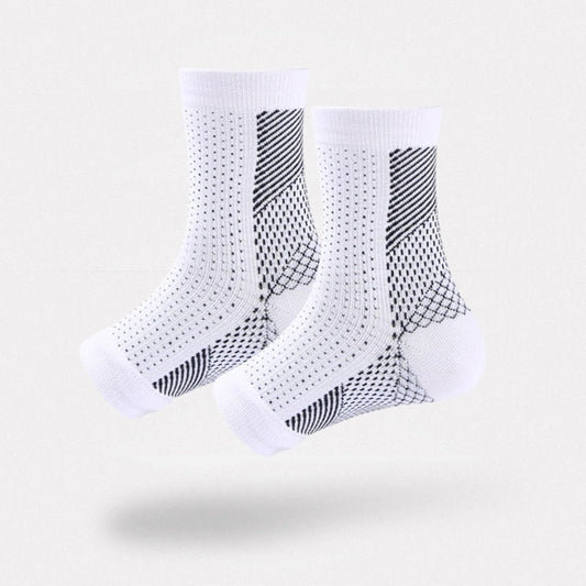 White and black anti-fatigue compression socks with flat seams, worn up the calf