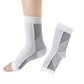White and black anti-fatigue compression socks with flat seams, worn up the calf