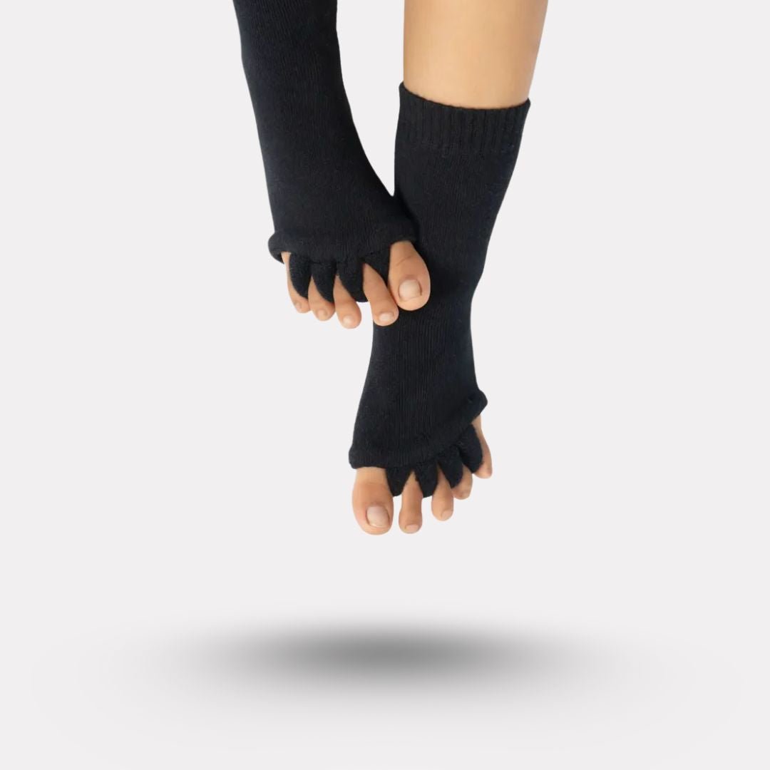 Bunion correction socks in black, gray, green and blue, worn over the forefoot and big toe