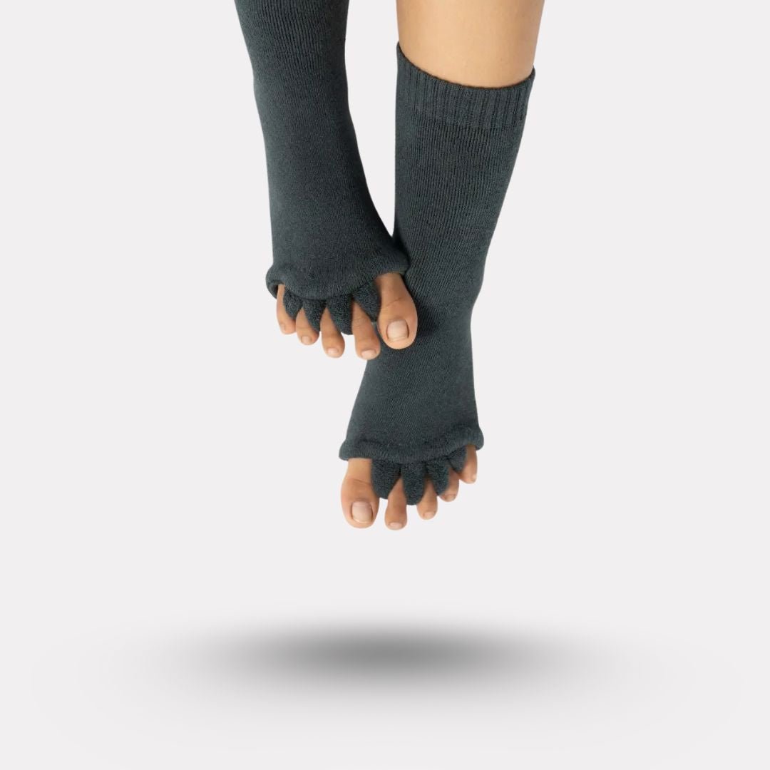 Bunion correction socks in black, gray, green and blue, worn over the forefoot and big toe