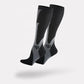 Black and white compression socks worn up the calf to support circulation