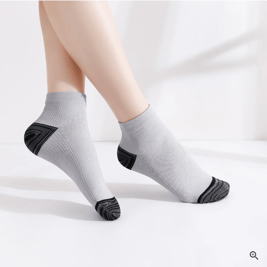 Gray compression socks with a firm band under the arch for plantar pain