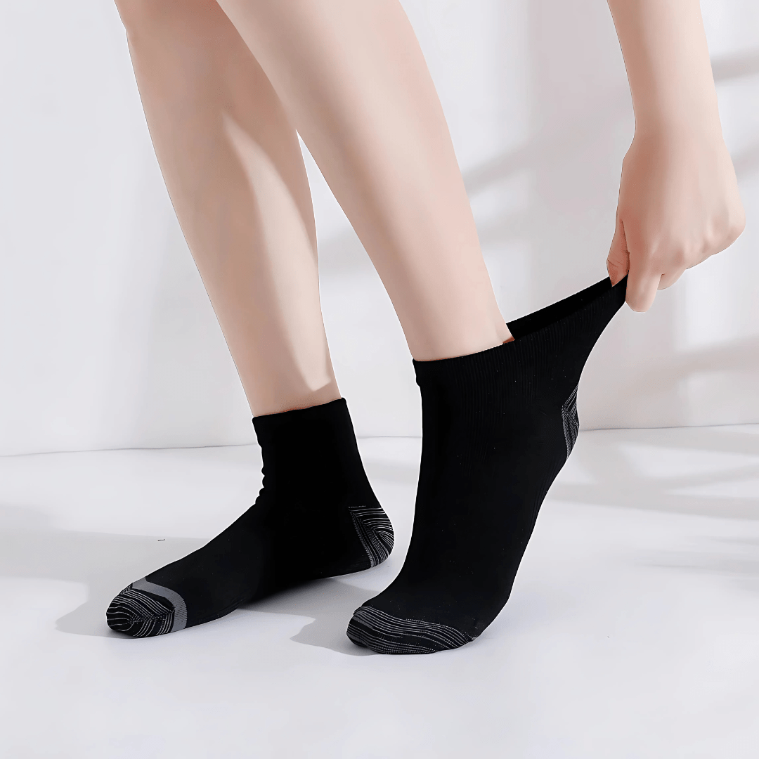Gray compression socks with a firm band under the arch for plantar pain
