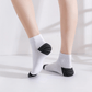 Gray compression socks with a firm band under the arch for plantar pain