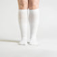 White seamless compression socks that stretch up the calf with no ridge at the toe